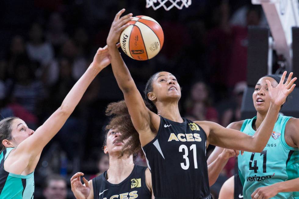 Aces guard Jaime Nared (31) fights for a loose ball with New York Liberty defenders Kiah Stokes ...