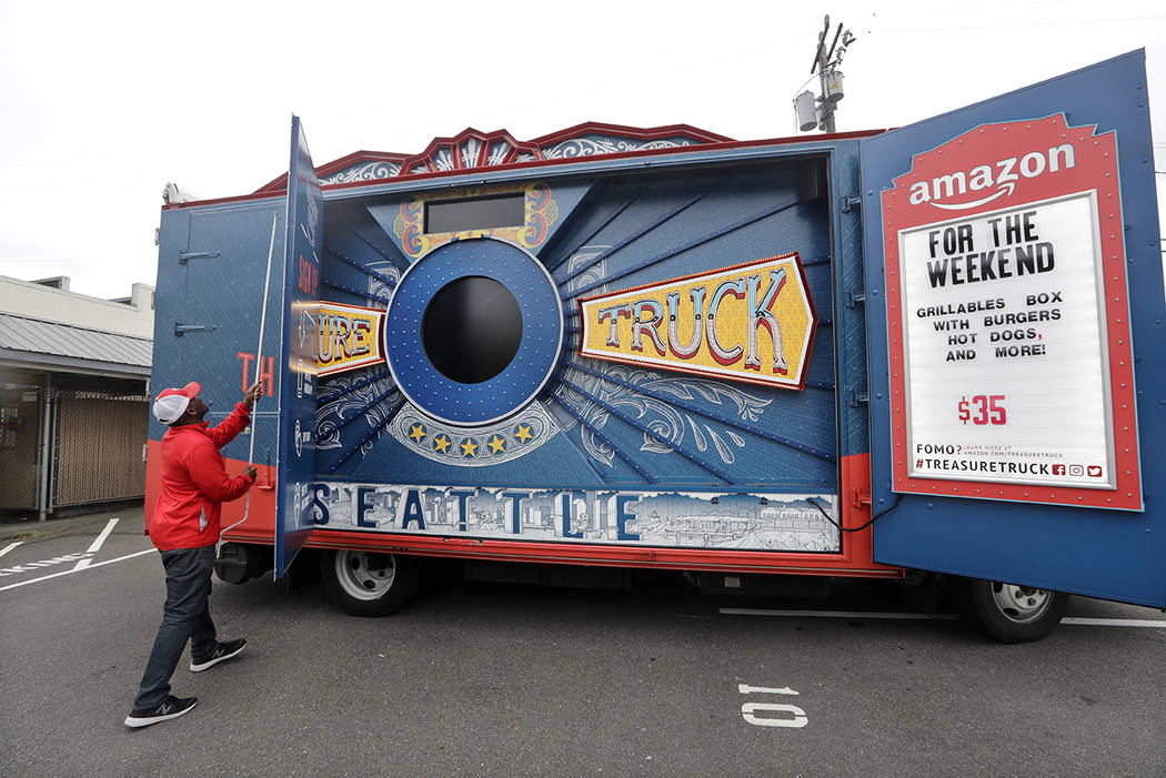 Amazon worker Khayyam Kain begins to open an Amazon Treasure Truck at a parking lot in Seattle, ...
