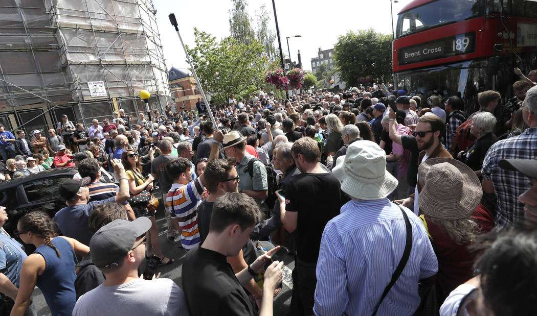 The road is blocked and the crossing obscured as thousands of fans gather to walk across the Ab ...