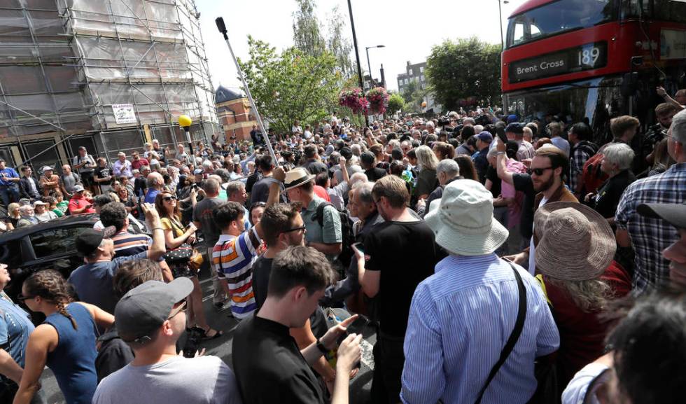 The road is blocked and the crossing obscured as thousands of fans gather to walk across the Ab ...