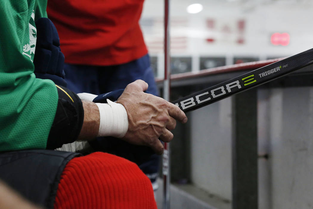 Player Sean McCrossan waits to go back onto the ice during Ronnie's Hockey Club, a pickup ice ...