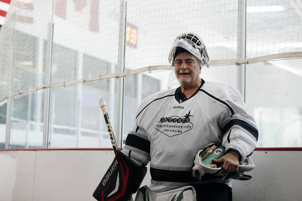 Goalie Dave Holm, 76, finishes a game during Ronnie's Hockey Club, a pickup ice hockey league a ...