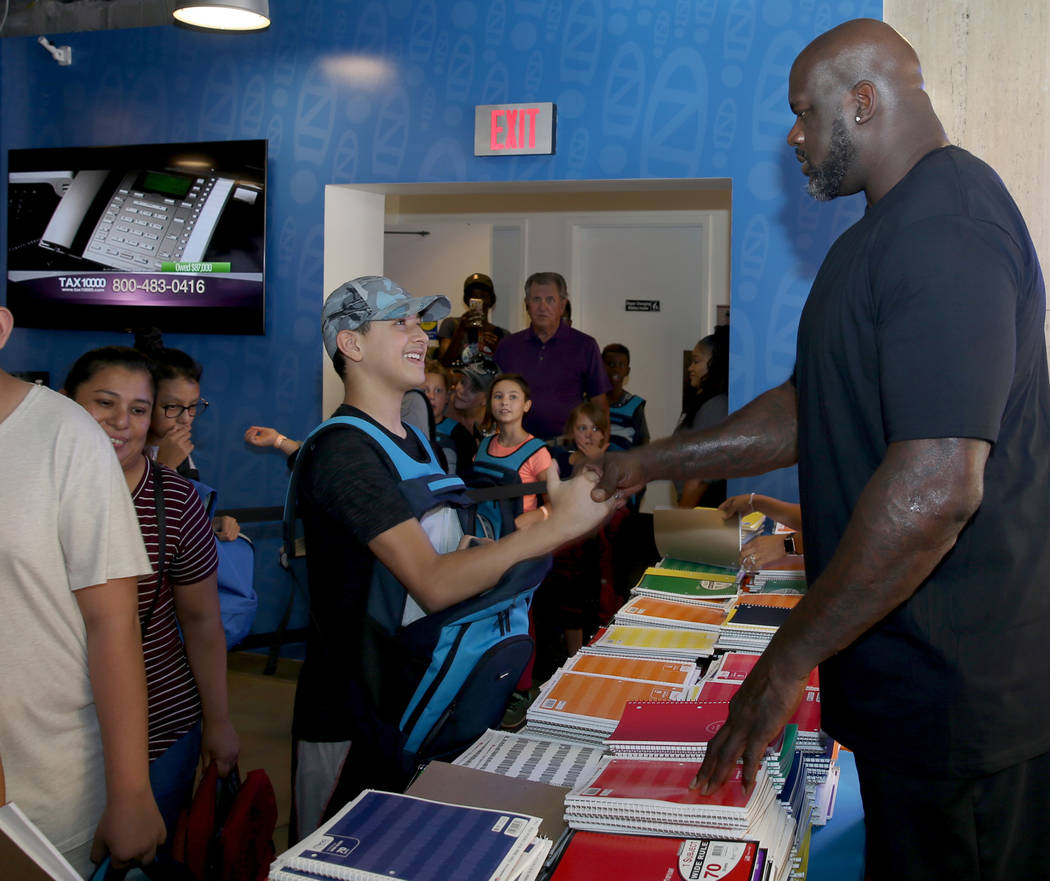 Salvador Rodriguez, 14, of Las Vegas shakes hands with former NBA star Shaquille O'Neal during ...