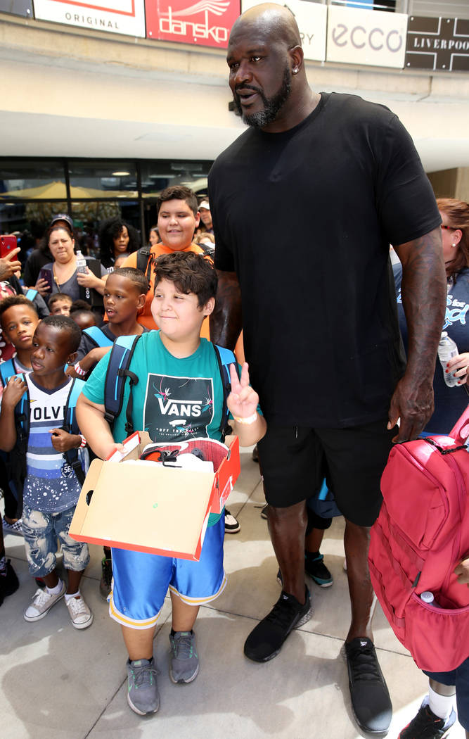 D'Angelo Avila, 10, of North Las Vegas poses with former NBA star Shaquille O'Neal during Shaq- ...