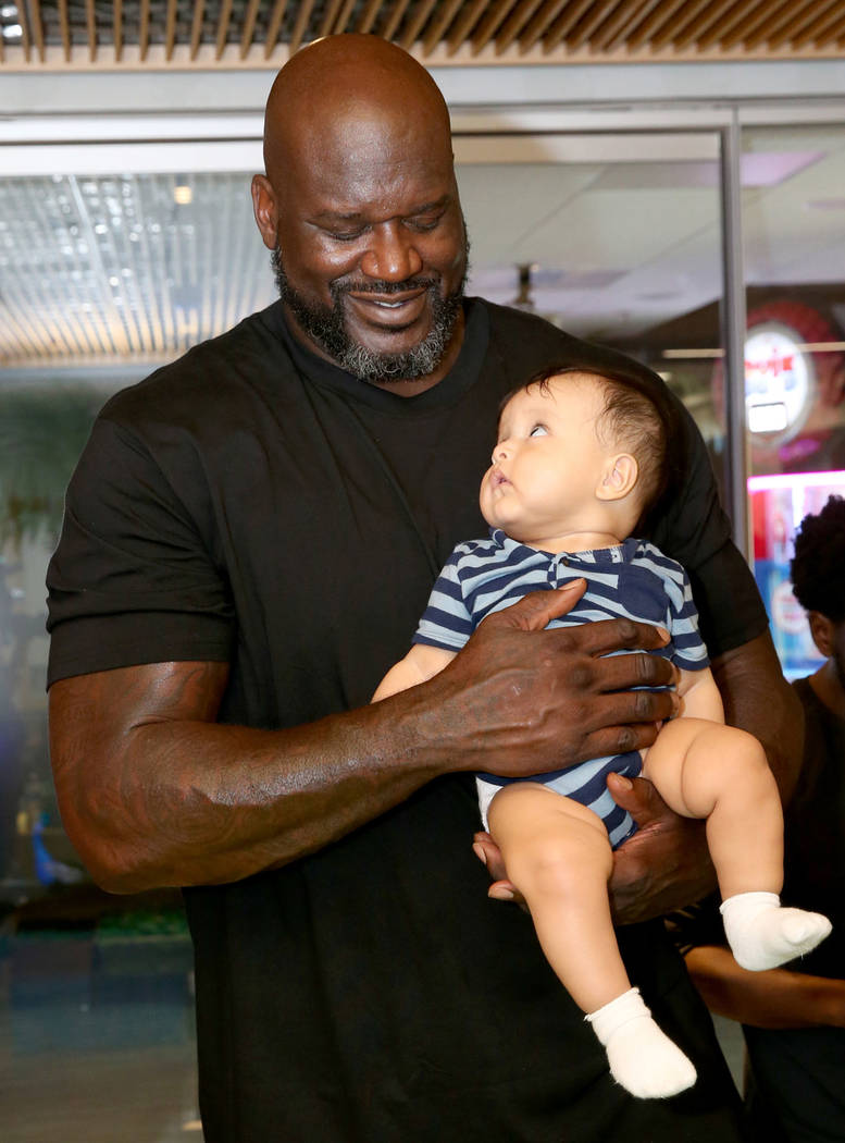 Former NBA star Shaquille O'Neal holds 8-month-old Tyler Bautista of Las Vegas during Shaq-to-S ...