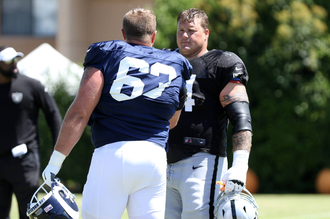 Los Angeles Rams center Vitas Hrynkiewicz (63) meets with Oakland Raiders offensive guard Richi ...
