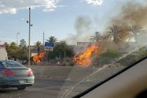 A fire burns near the southbound lanes of I-15 in Las Vegas on Thursday, Aug. 8, 2019. (Rochell ...