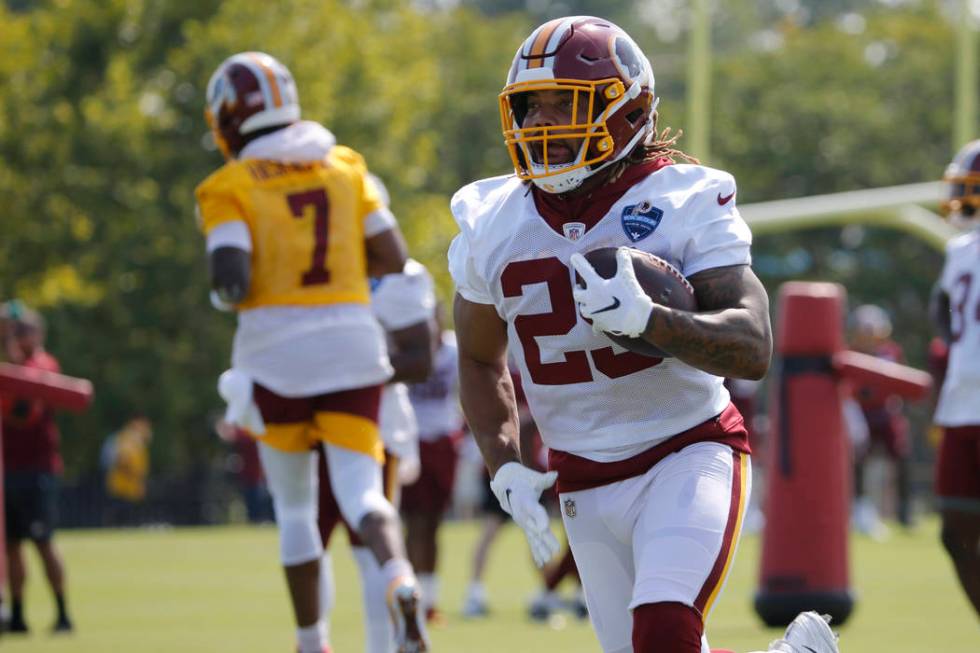 Washington Redskins running back Derrius Guice (29) runs a drill during the NFL football traini ...