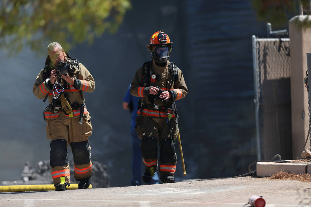 Firefighter leave the scene of a structural fire near the intersection of Losee Road and West L ...