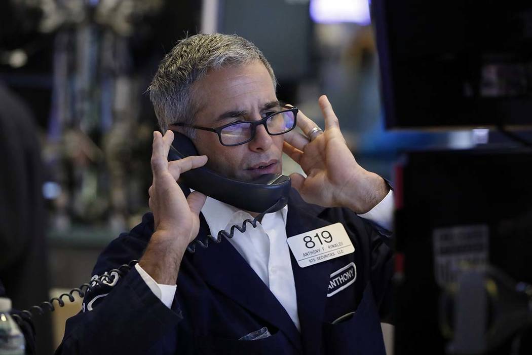 Specialist Anthony Rinaldi works on the floor of the New York Stock Exchange, Friday, Aug. 9, 2 ...