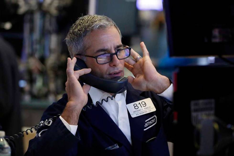 Specialist Anthony Rinaldi works on the floor of the New York Stock Exchange, Friday, Aug. 9, 2 ...