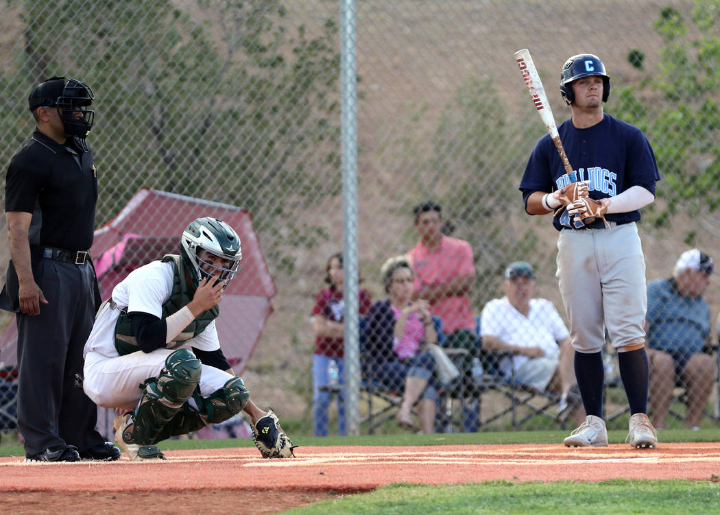 Centennial High School outfielder Austin Kryszczuk, right, prepares to bat as Palo Verde catche ...