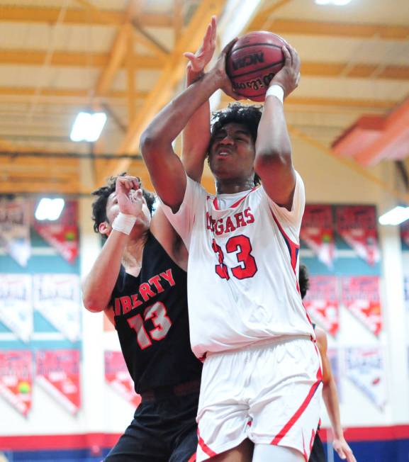 Coronado's Jhaylon Martinez (33) takes an elbow from Liberty's Terrance Marigney (13) in the fi ...