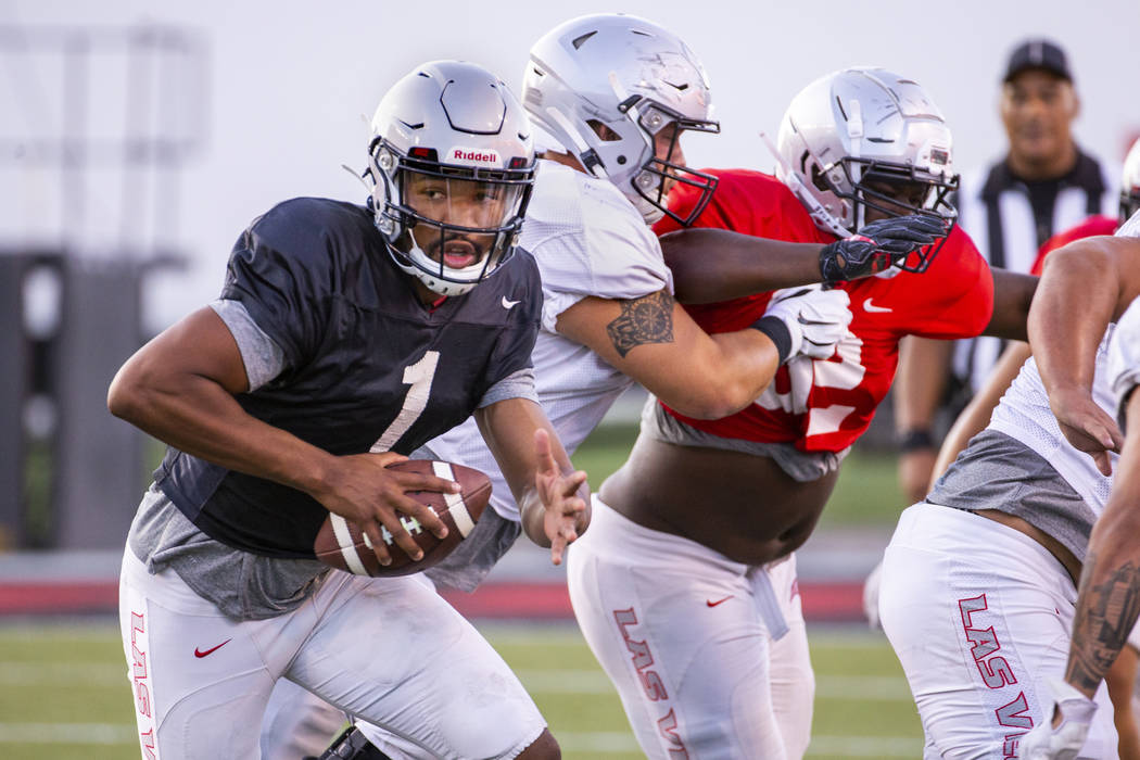 UNLV QB Armani Rogers (1) looks for room to run during their first major scrimmage of football ...