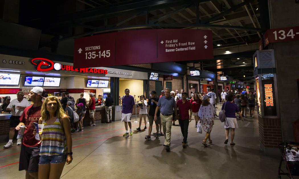 Fans walk the concourse before the start of an Arizona Diamondbacks baseball game against the P ...