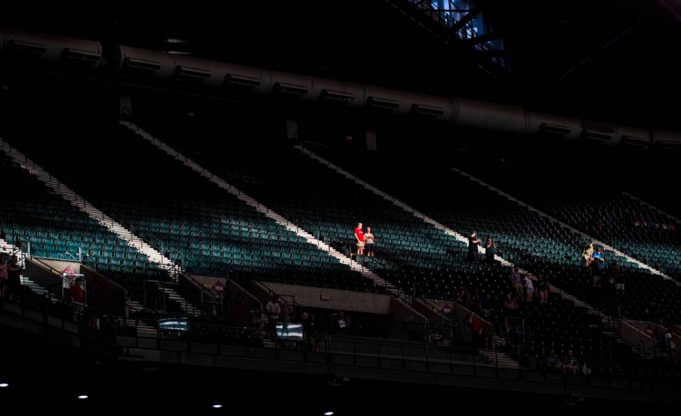 Fans are highlighted by a strip of sunlight before the start of an Arizona Diamondbacks basebal ...