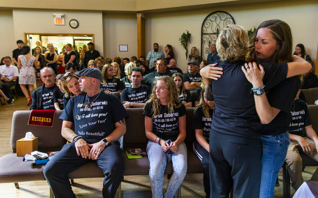 Harlee Deborski's stepmother Amanda Deborski, right, receives a hug as she and family members g ...