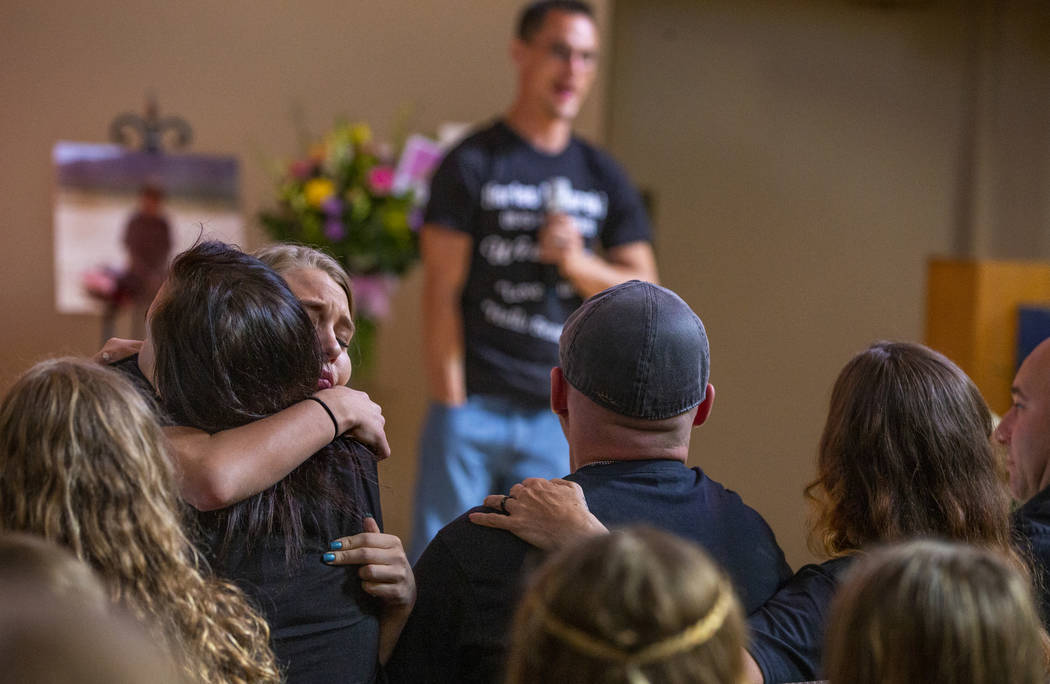Chloe Lasping, left, hugs a sibling of Harlee Deborski during the funeral service for him in th ...