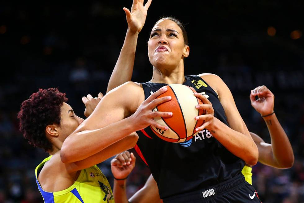 Las Vegas Aces' Liz Cambage drives to the basket against Dallas Wings' Isabelle Harrison during ...