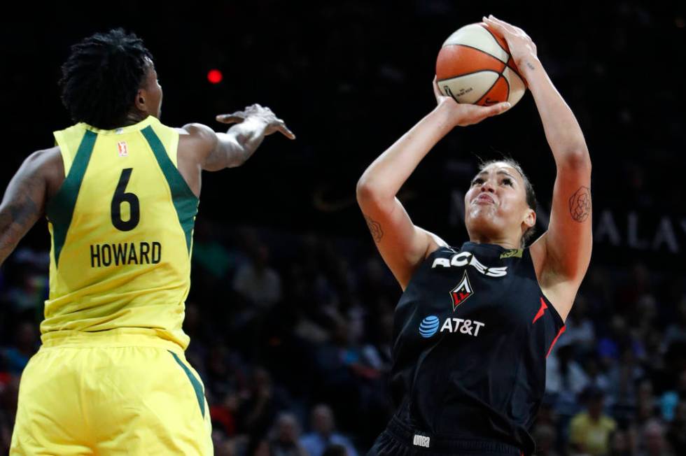 Las Vegas Aces' Liz Cambage shoots around Seattle Storm's Natasha Howard during the first half ...