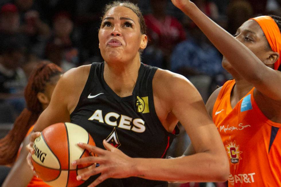 Las Vegas Aces center Liz Cambage (8), left, goes to the hoop against Connecticut Sun center Jo ...