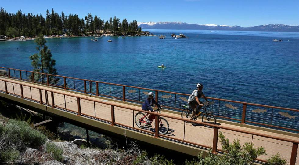 FILE - This June 25, 2019, file photo, shows cyclists riding along Lake Tahoe near Glenbrook, N ...