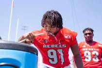 UNLV's defensive line Nate Neal (91) hydrates during the team's photo day at Sam Boyd Stadium i ...