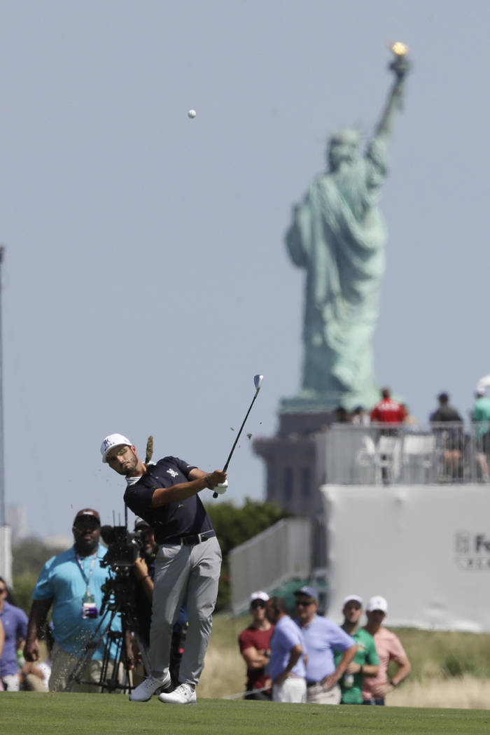 Abraham Ancer, of Mexico, hits from the third fairway in the final round in the Northern Trust ...