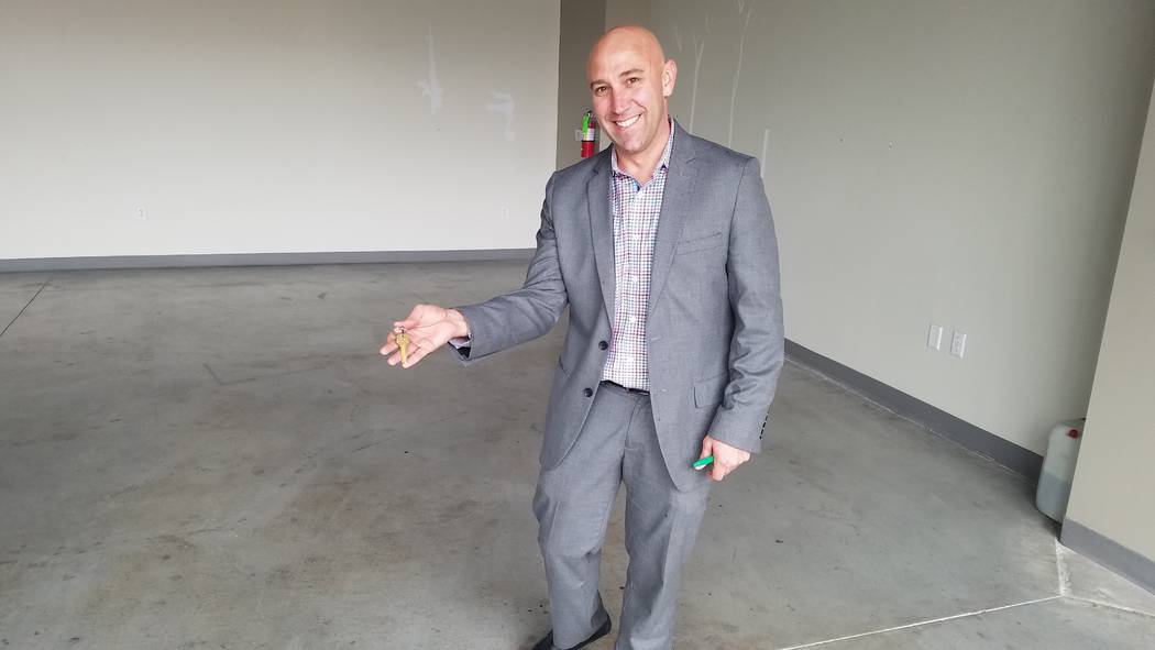 Lexicon Bank CEO John Miller shows off the keys to the bank's future location at Tivoli Village ...