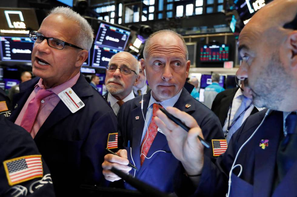 Michael Urkonis, second from right, works with fellow traders on the floor of the New York Stoc ...