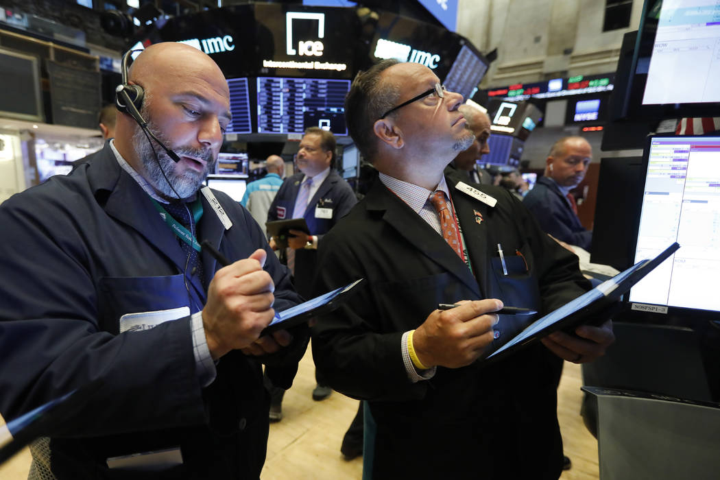 Traders Vincent Napolitano, left, and Robert Arciero work on the floor of the New York Stock Ex ...