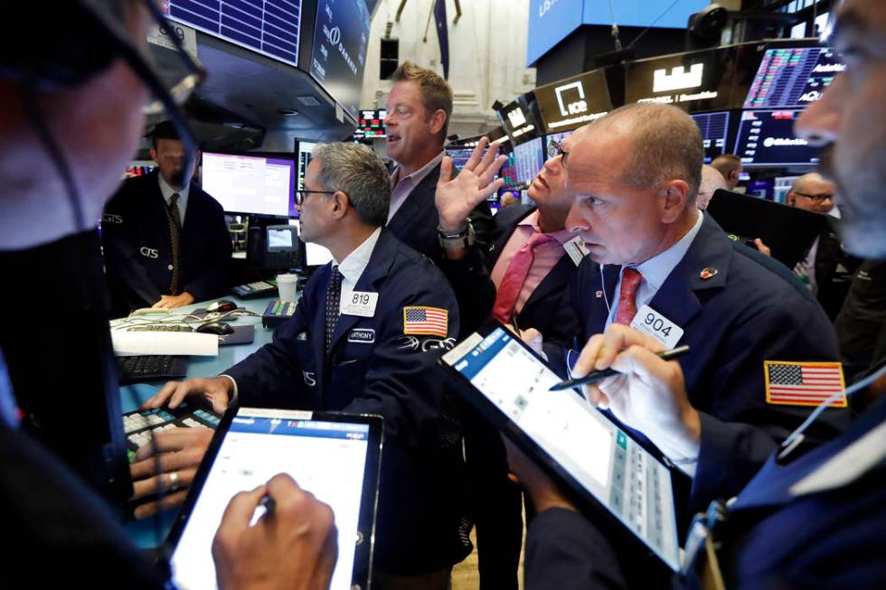 Specialist Patrick Murphy, background center, works with traders on the floor of the New York S ...