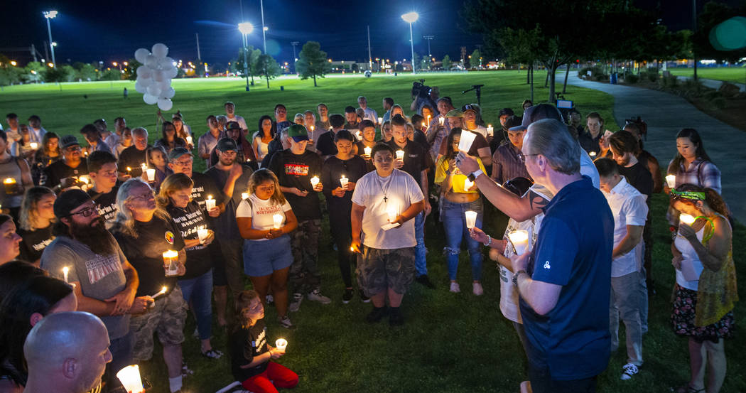 Mourners gather and listen to Jason Deborski speak during a candlelight vigil for Harlee Debors ...