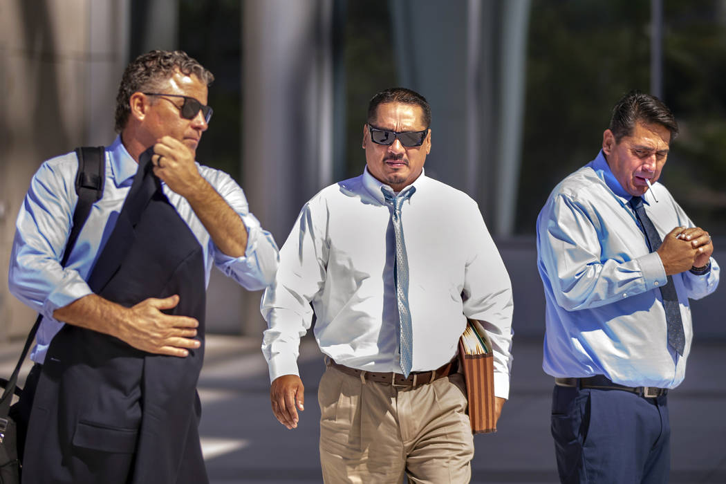 Counselor Mark Fleming, left, and defendant Albert Lopez walk past defendant Bradley Campos out ...