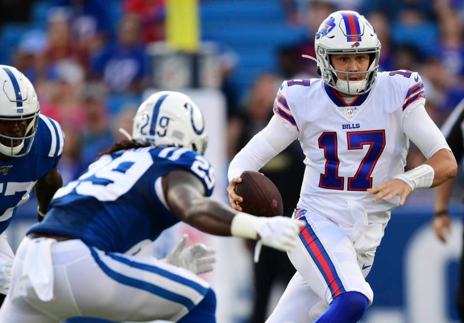 Buffalo Bills quarterback Josh Allen (17) runs with the ball during the first half of an NFL pr ...