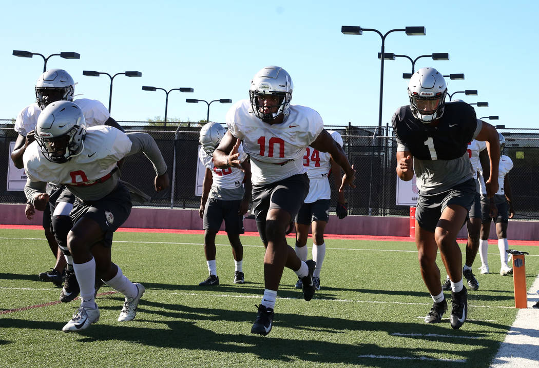 UNLV Rebels quarterback Armani Rogers (1) and wide receiver Darren Woods Jr. (10), second right ...