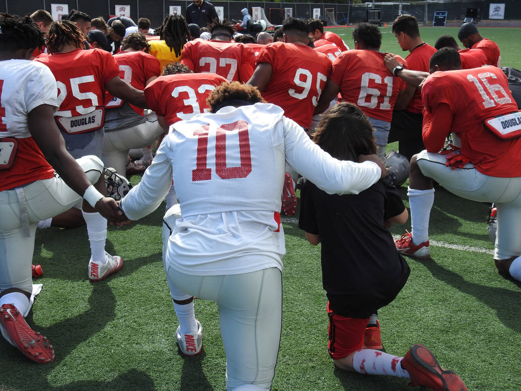 UNLV wide receiver Darren Woods Jr. (No. 10) put his arm around Thaddeus Thatcher, who signed h ...