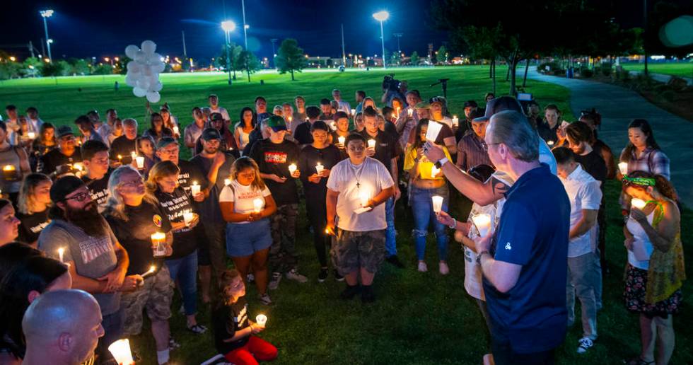 Mourners gather and listen to Jason Deborski speak during a candlelight vigil for Harlee Debors ...