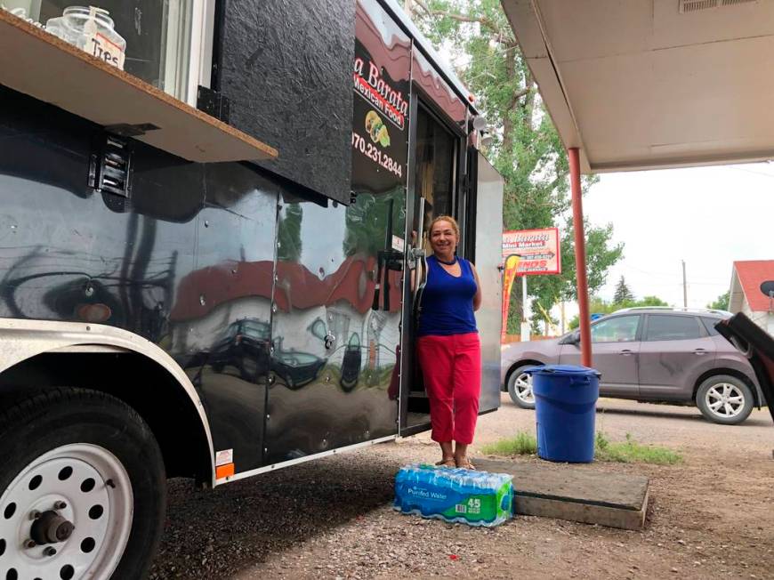 In this Aug. 1, 2019 photo Nena Hermosillo stands outside her taco truck in Cheyenne, Wyo. Chey ...