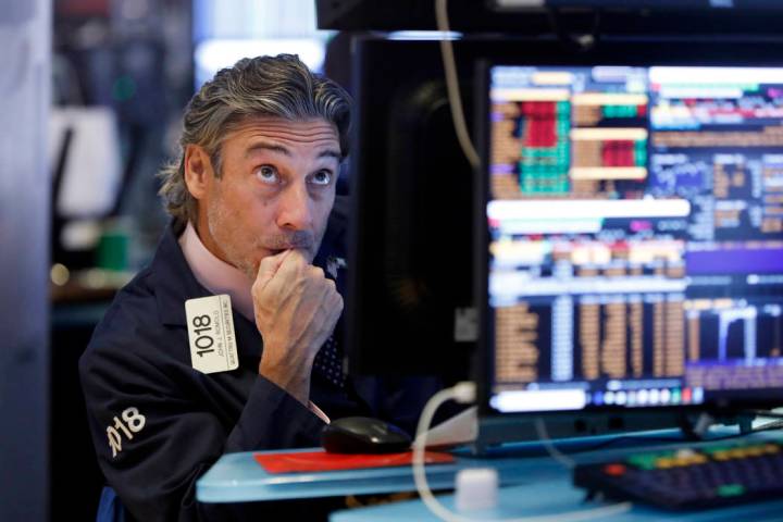 Trader John Romolo works on the floor of the New York Stock Exchange, Wednesday, Aug. 14, 2019. ...