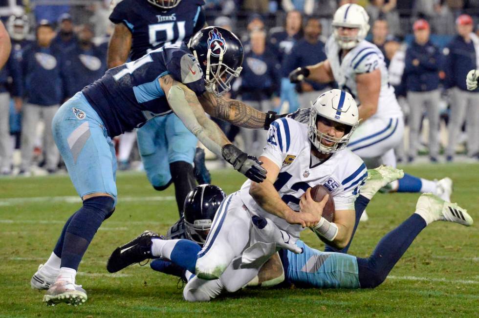 Indianapolis Colts quarterback Andrew Luck (12) is brought down as he scrambles against the Ten ...