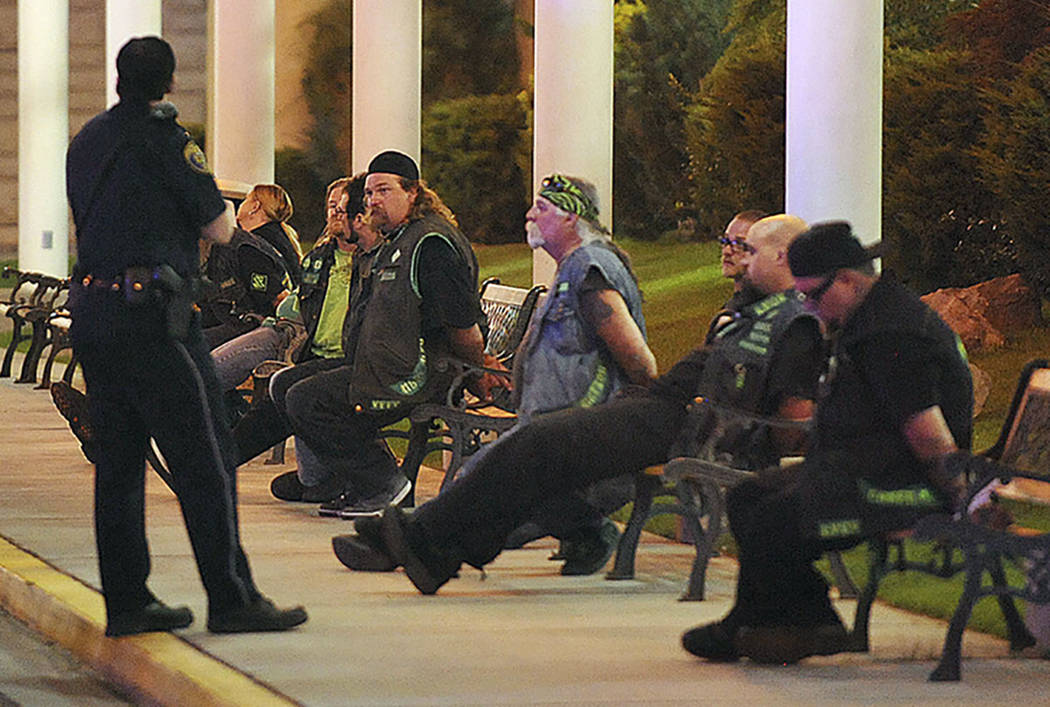 Police officers keep an eye on handcuffed men at the east entrance to John Ascuaga's Nugget aft ...