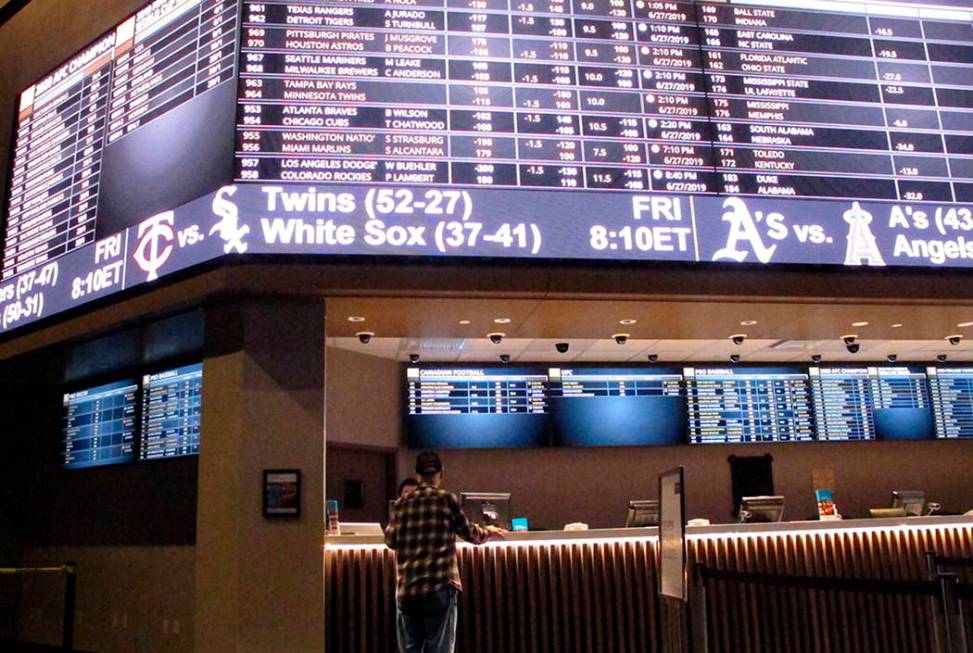 A customer ponders the odds at the new sportbook at Bally's casino in Atlantic City, N.J., in J ...