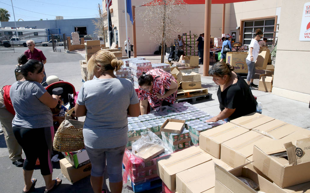 People pick up food during a food bank distribution at Veterans Village in downtown Las Vegas, ...