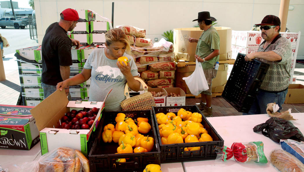 Carina Lopez picks up food during a food bank distribution at Veterans Village in downtown Las ...