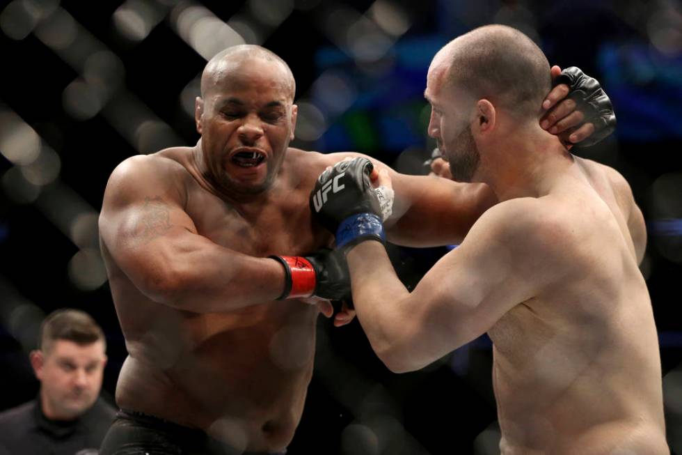 Daniel Cormier, left, exchanges blows with Volkan Oezdemir during a light-heavyweight champions ...