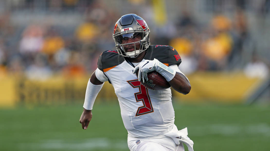 Tampa Bay Buccaneers quarterback Jameis Winston (3) scrambles during the first half of an NFL p ...
