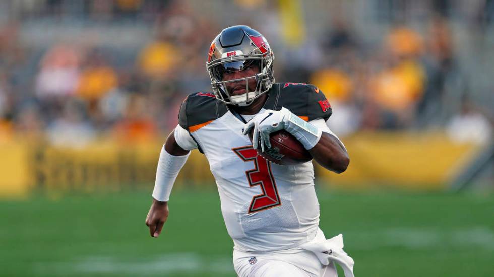 Tampa Bay Buccaneers quarterback Jameis Winston (3) scrambles during the first half of an NFL p ...