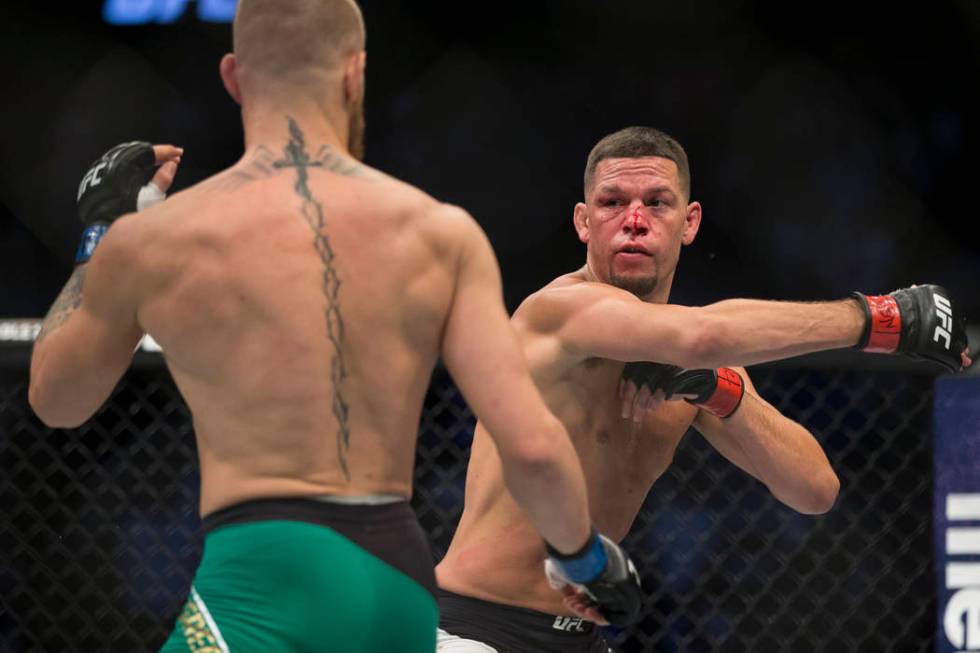 Conor McGregor, left, battles Nate Diaz in the welterweight bout during UFC 202 at T-Mobile Are ...