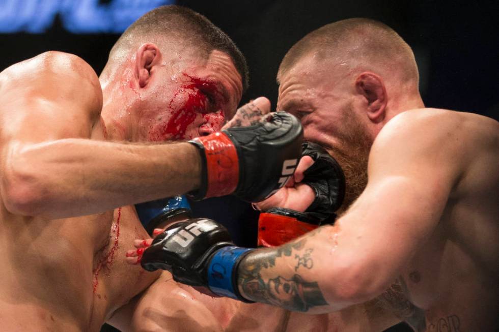 Nate Diaz, left, battles against Conor McGregor in the welterweight bout during UFC 202 at T-Mo ...